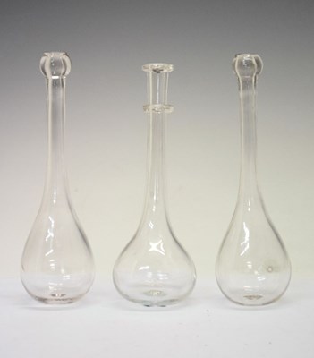 Lot 437 - Pair of clear glass of plain toddy lifters, together with a ring-necked example