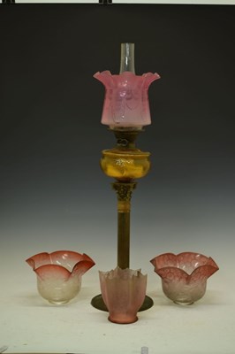 Lot 595 - Cranberry column oil lamp and shades