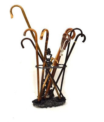 Lot 686 - Cast metal stick stand with assorted sticks
