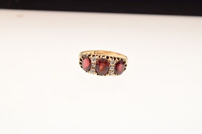 Lot 26 - George V 18ct gold three stone garnet ring