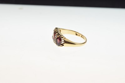 Lot 26 - George V 18ct gold three stone garnet ring