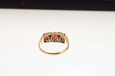 Lot 26 - George V 18ct gold three stone garnet ring