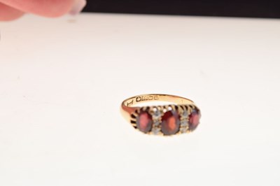 Lot 26 - George V 18ct gold three stone garnet ring