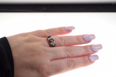 Lot 26 - George V 18ct gold three stone garnet ring