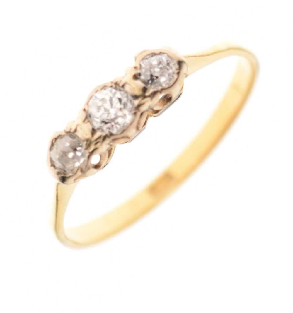 Lot 4 - '18c' yellow metal three-stone diamond ring