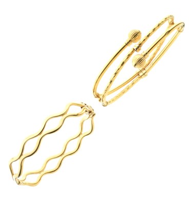 Lot 23 - Two yellow metal bangles
