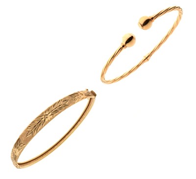 Lot 24 - Two yellow metal hinged bangles