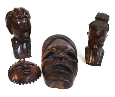 Lot 621 - Two African hardwood busts, together with two wall masks