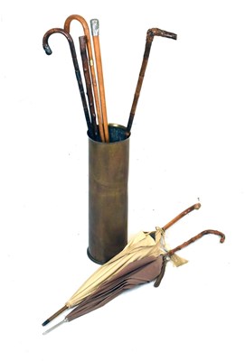 Lot 607 - 1960s shell case stick stand with a quantity of sticks