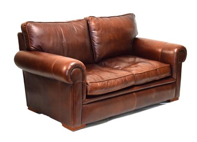 Lot 743 - Two seater sofa upholstered in brown leather