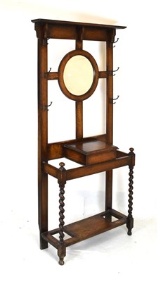 Lot 718 - Oak hallstand, having central circular mirror, and barley twist supports