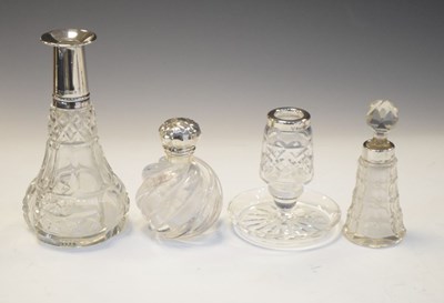 Lot 205 - Elizabeth II silver stamp moistener, three silver dressing table bottles and candle/pin stand