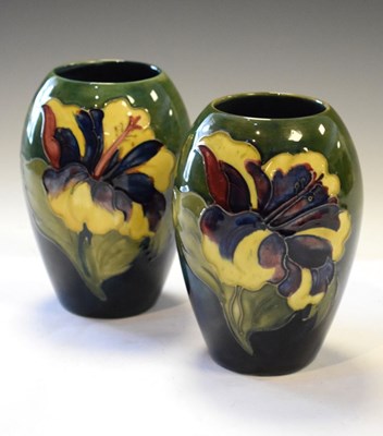 Lot 382 - Moorcroft - Pair of Hibiscus pattern green ground ovoid vases